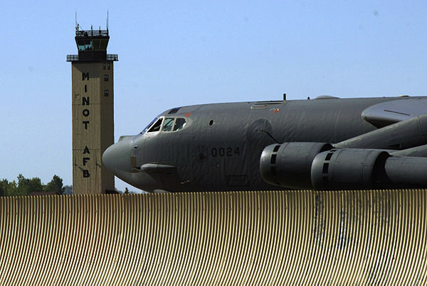 A 5th Bomb Wing Boeing B-52 taxis past the Minot AFB tower