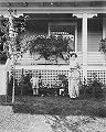 McClung outside her house with her son and dog, 1910.