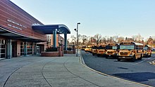 The Northwestern High School front facade with the C-Wing in the foreground Northwestern Facade & Bus Traffic.jpg