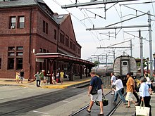 Passengers crossing the State Street crossing in New London after departing a northbound train Passengers crossing State Street.JPG