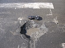 Shallow potholes in a road surface. Pothole in Villeray, Montreal.jpg