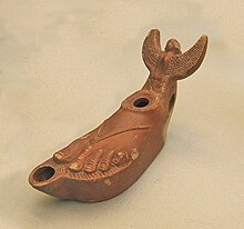 Terracotta lamp in the shape of a foot, with a sphinx or siren as the handle Roman pottery foot-shaped lamp.JPG