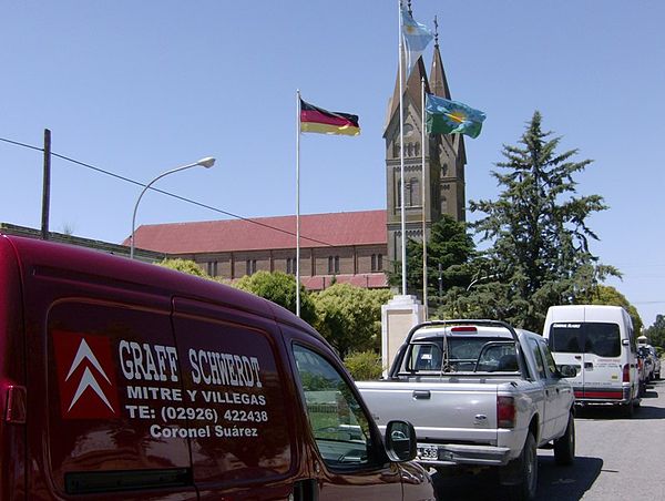 Flags of Argentina, Buenos Aires Province and Germany in front of St. Joseph Catholic Church in San José, Coronel Suárez Partido, Argentina (Volga Ger