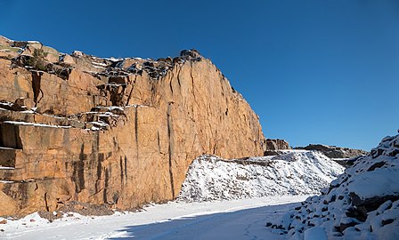 Snow on granite cliffs in Rixö quarry