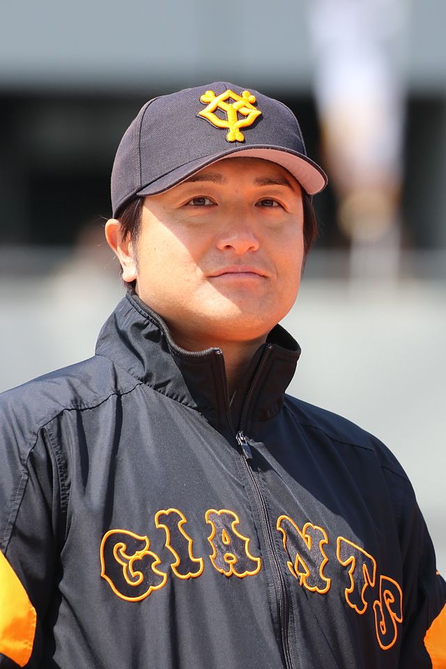 TOKYO, Japan - Yomiuri Giants manager Tatsunori Hara (2nd from L) joins  players of his team in showing off the Japanese professional baseball  club's new uniforms in Tokyo on Dec. 22, 2014