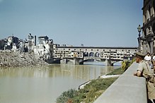 British officer views the damage to the Ponte Vecchio from the east just after the liberation of Florence on August 11, 1944, during World War II The Ponte Vecchio bridge in Florence, damaged by the retreating Germans who blew up buildings at each, 14 August 1944. TR2293.jpg