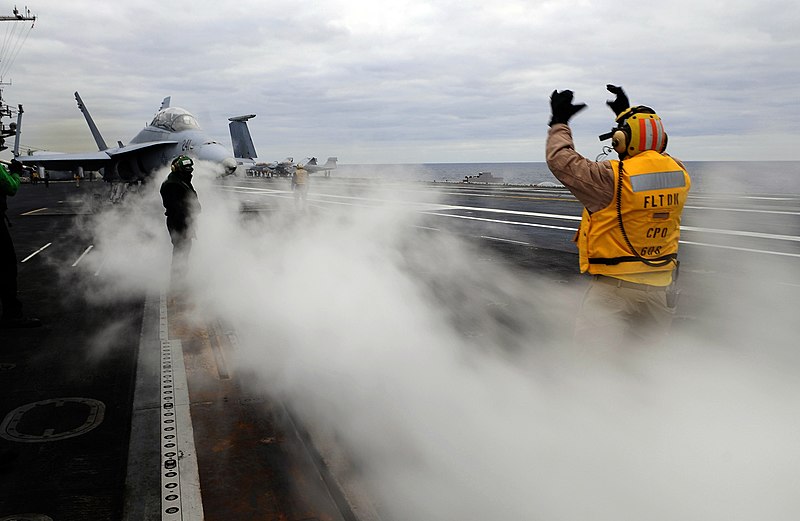 File:US Navy 091209-N-9928E-273 Chief Aviation Boatswain's Mate (Handling) Victor Cadena, from Los Angeles, directs an F-A-18C Hornet.jpg