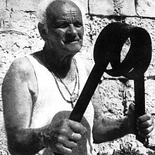 Anthony 'il-Walker' Zarb showing off a piece of scrolled steel in his later years. Anthony Zarb il Walker in his retirement years.jpg