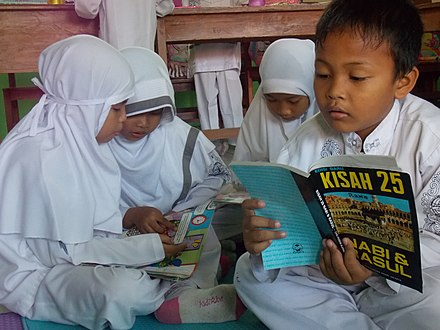 Boys and girls students are studying together in their classroom.