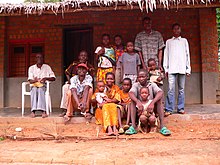 A family from Basankusu, Democratic Republic of the Congo. Basankusu - typical fired brick house.jpg