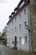 Residential house with extensions and original fencing in semi-open development, adjoining the Nicolaiturm