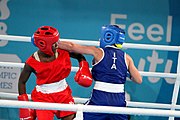 Deutsch: Boxen bei den Olympischen Jugendspielen 2018 Tag 12, 18. Oktober 2018 - Finale Fliegengewicht Mädchen – Martina La Piana (Italien, blau) schlägt Adijat Gbadamosi (Nigeria, rot) 5-0; Ringrichter ist James Beckles (Trinidad und Tobago). English: Boxing at the 2018 Summer Youth Olympics on 18 October 2018 – Girl's flyweight Gold Medal Bout - Martina La Piana (Italy, blue) beats Adijat Gbadamosi (Nigeria, red) 5-0; Referee is James Beckles (Trinidad and Tobago). Español: Boxeo en los Juegos Olímpicos Juveniles de Verano de 2018 en 18 de octubre de 2018 - Combate a medalla de oro de peso mosca para mujeres: Martina La Piana (Italia, azul) le gana a Adijat Gbadamosi (Nigeria, roja) 5-0; El árbitro es James Beckles (Trinidad y Tobago).