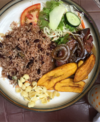 Casado, which includes gallo pinto, salad, meat and fried plantains