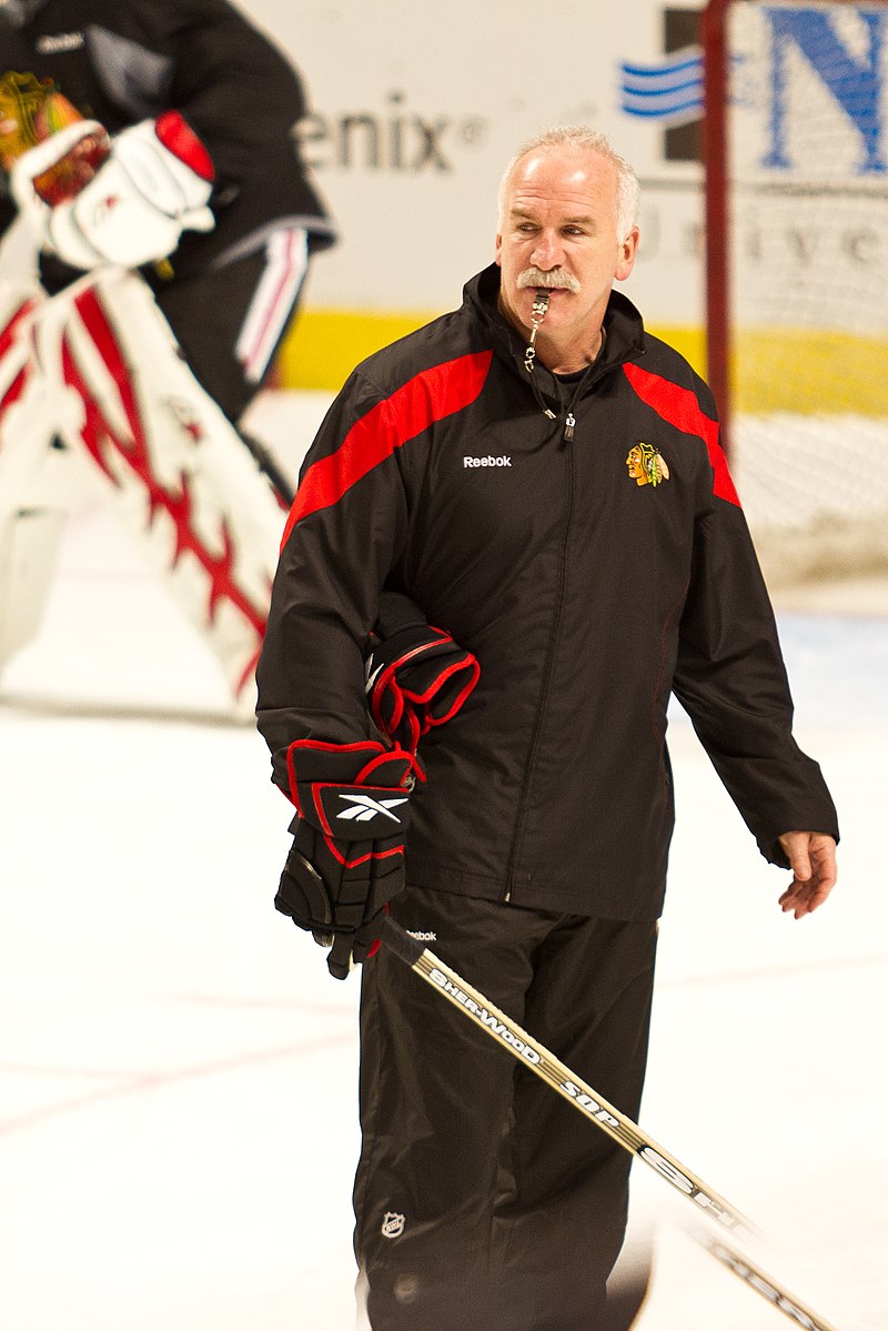 Colorado Avalanche head coach Joel Quenneville (R) wears his old