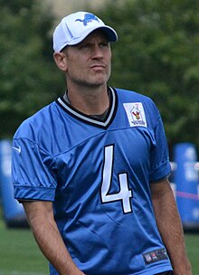Jason Hanson pictures from the waist up in a Detroit Lions jersey and hat.