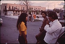 A young woman talking with a group of young men in El Segundo Barrio, El Paso (1971) EL PASO'S SECOND WARD, A CHICANO NEIGHBORHOOD - NARA - 545331.jpg