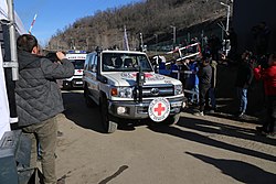 ICRC vehicle facilitating the transfer of a patient in need of urgent medical assistance across the Lachin road to Armenia. Environmental action on Lachin - Khankendi road (International Committee of the Red Cross).jpg