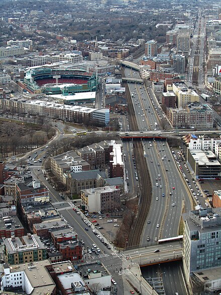 View of the Massachusetts Turnpike in Boston's Fenway–Kenmore neighborhood, seen from the Prudential Tower. Fenway Park is visible at top left