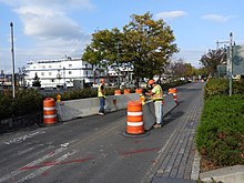 Temporary barrier installation in Midtown Installing 40th Street barrier HRGW jeh.jpg