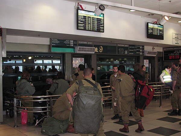 Israeli soldiers wait to board intercity buses at an indoor platform on the third floor.
