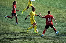 Kezban Tağ (yellow) of Kireçburnu Spor in the 2015-16 Women's First League match against Konak Belediyespor.