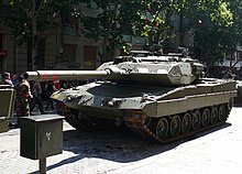 Leopard 2E der spanischen Armee bei einer Parade in Saragossa im Jahr 2008. Gut erkennbar sind die zusätzliche Wannenpanzerung und der Bombletschutz auf dem Turmdach.