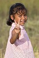 Little girl giving V-sign in the sunshine in Laos.jpg