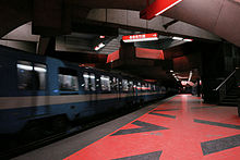 A train departs from Acadie station. The Montreal Metro has 68 stations and four lines.