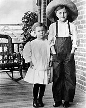 Loy (left) at age six, standing on her grandmother's porch in Helena, Montana, with her cousin Laura Belle Wilder (1911) Myrna-Loy-1911.jpg