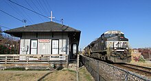 A train rolls past the former Wabash station (now an ice cream parlor) in Ferguson. Norfolk Southern Train 285 Runs past Ferguson Train Station.JPG