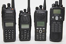 Several portable two-way radios designed for public services (police, fire, rescue) compatible with the Project 25 digital radio standard P25 hand-held radios.jpg