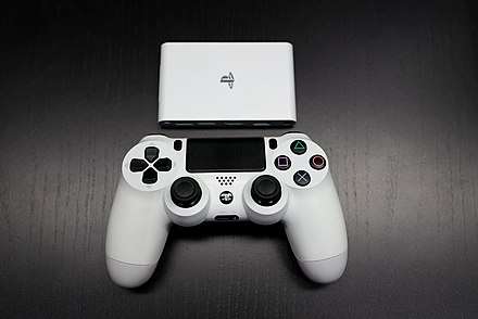 A white PlayStation TV and DualShock 4 controller.
