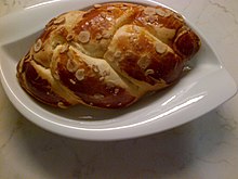 Braided Easter bread garnished with slivered hazelnuts