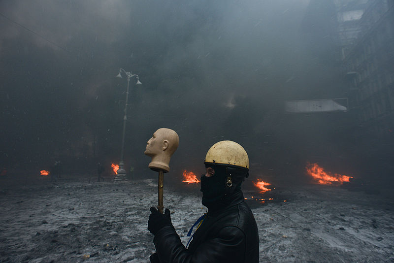 File:Protester marching through Grushevskogo str. covered with smoke of the fire set by the protesters to prevent internal forces from crossing the barricade line. Kyiv, Ukraine. Jan 22, 2014.jpg
