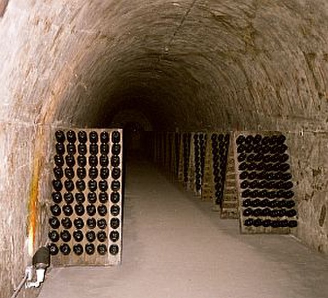 Champagne bottles in racks in underground cellars