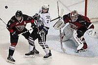 Hicketts (middle) battles Brett Kulak (left) during the 2013-14 WHL season with the Victoria Royals. Royals vs Giants Jan 31 2014.jpg