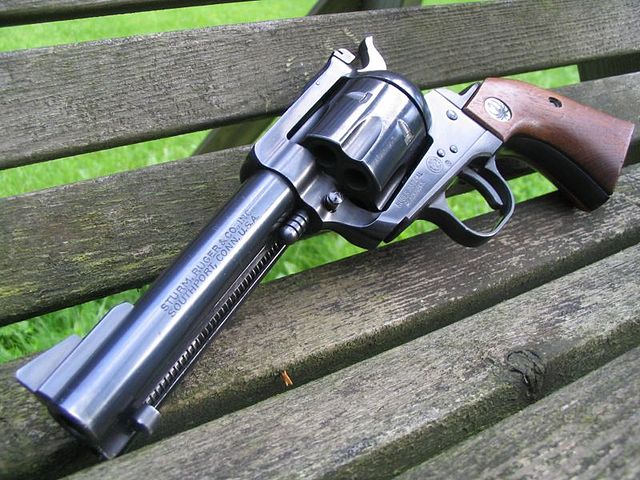 A .357 Magnum/9mm convertible Ruger Blackhawk in blued finish, with Adjustable Sights, and a 4 5/8" Barrel