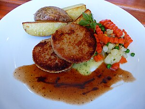 two Jägerschnitzel with potato and mixed vegetables