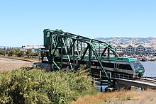 SMART Nippon Sharyo DMU crossing the Haystack Landing Bridge over the Petaluma River SMART train crossing Haystack Landing bridge.jpg