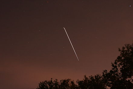 Atlantis docked with the ISS moving southeast across the skies of Tampa, Florida