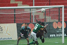 Salgaocar player (green) in action against ONGC during the 121st Osian's Durand Cup in New Delhi, 2008. The Football player chasing the goal of the 121st Osian's Durand Football Tournament-2008 between the ONGC and Salgaocar SC, in New Delhi on August 23, 2008.jpg