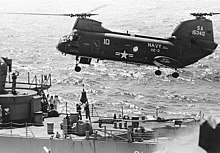 A UH-46D lowers mail to the fantail of USS Decatur.