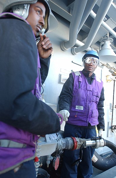 File:US Navy 030226-N-6141B-005 Engineman Fireman Calvin Lucas communicates to the ship's fuel console operator during a replenishment at sea operation.jpg