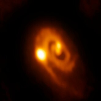 The triple protostar system IRS 3B and the disk of the system. Young Stellar System Caught in the Act of Forming Close Multiples.jpg