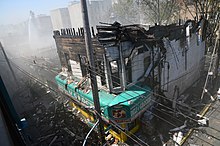 This row of small businesses was destroyed in a five-alarm fire in New York City in 2013 5-Alarm Fire, White Plains Rd. (8701830781).jpg