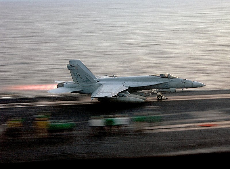 File:A US Navy (USN) F-A-18C Hornet multi-mission fighter-attack aircraft launches from the flight deck of the Nimitz Class Aircraft Carrier, USS RONALD REAGAN (CVN 76), while the USS RO - DPLA - 18be38db42aa624f9c97559d0ed97e47.jpeg