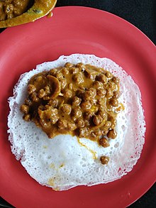 Appam served with chickpea curry from Kerala