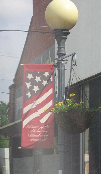 Streetlight banner proclaiming Brewton as "Home of the Alabama Blueberry Festival"