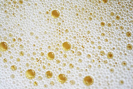 As the bubbles rise to the surface of the glass, they form a frothy mousse.