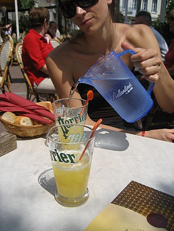 The French soft drink citron pressé, being diluted with water